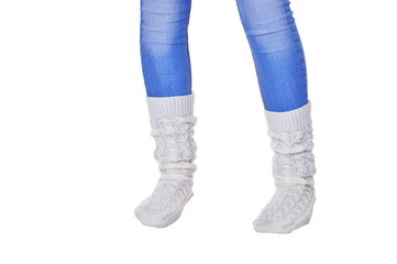 Cropped shot of girl wearing blue jeans and white socks on white background