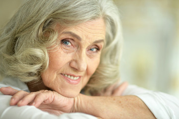 Beautiful smiling senior woman posing at home