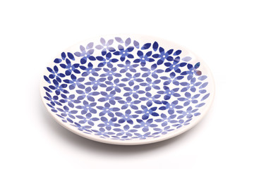 painted plate in blue flower isolated on white .