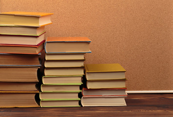 Stack of books on cork  background.Education.