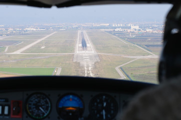 A runway viewed from a small aircraft's cockpit during approaching