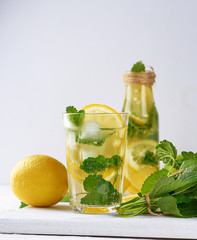 summer refreshing drink lemonade with lemons, mint leaves, lime in a glass