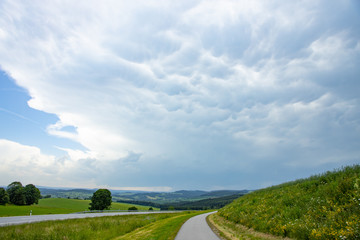 Fototapeta na wymiar supercell dark clouds rain. over the green field mammoth
