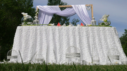White decoration of the wedding in the green garden.