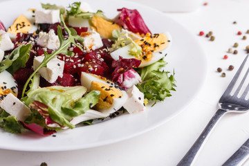 Fresh mixed salad in a bowl on a white background