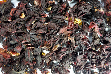 Dried flowers petals background. Red, yellow and brown colors backdrop for design projects. Sudan rose karkade tea