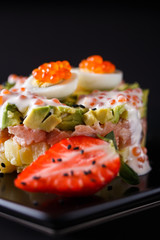Round salad made of red fish potato and avocado