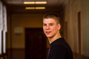 Portrait of a young guy, close-up. Teen face covered with acne