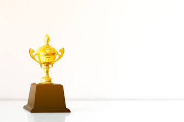 champion golden trophy on white table
