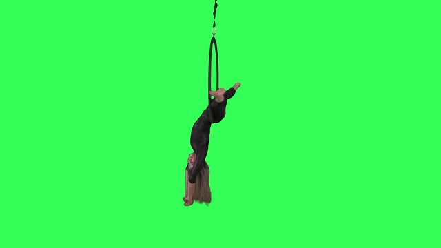Beautiful Aerial hoop artist spins upside down over a green screen