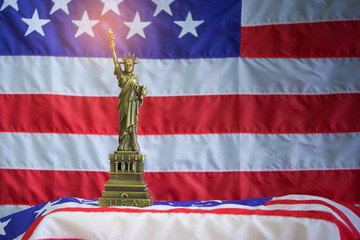 Obraz premium Peace goddess model is placed on the flag floor and has a background of the US flag.