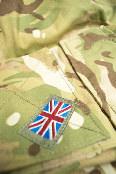 Union Jack / union flag arm badge on a British army uniform. Potential copy space above badge.