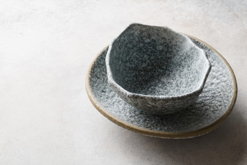 Fototapeta na wymiar Empty ceramic bowls on concrete gray background.