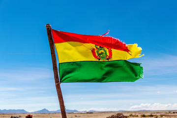 Bolivian Flag waving in the wind against blue sky background