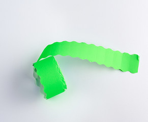 coil with green empty sticky price tags on white background