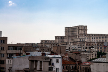Legacy of communism and landmarks of Romania concept theme with the People's house (casa poporului) surrounded by communist apartment buildings. The building serves as Romanian palace of parliament