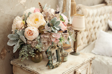 vintage room in a photo studio with a vintage wooden table with flowers and other elements of vintage style