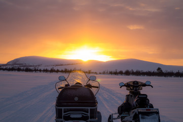 Snowmobile watching the sunset