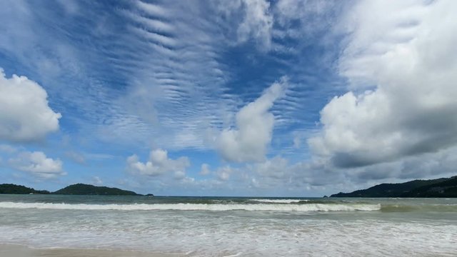4K Time lapse of blue sky with clouds on the beach