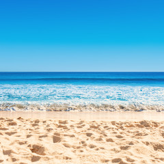 Fototapeta na wymiar Blue ocean wave on sandy beach. Tropical Summer Vacation concept .