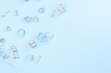 Festive blue background with silver spirals.