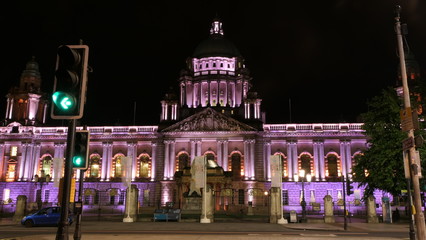 Fototapeta na wymiar The City Hall of Belfast iluminated with a green traffic light in the night, Northern Ireland