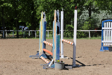 Outdoors photo of wooden barriers for jumping horses. Preparation of horses for performance on equestrian training