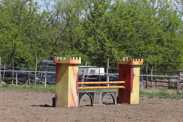 Outdoors photo of wooden barriers for jumping horses. Preparation of horses for performance on...