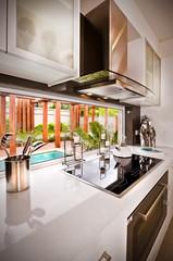 Kitchen with silverware and candles beside a glass window