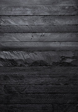 Black wood texture vertical wall background top view.