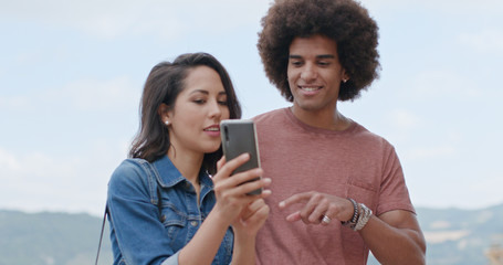 Romantic couple taking a selfie with smartphone in rural town of Assisi.Portrait medium...