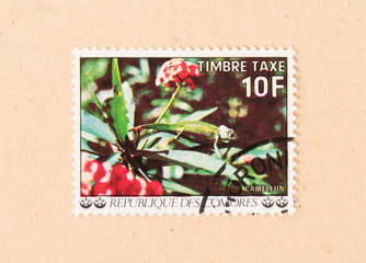 COMOROS - CIRCA 1980: A stamp printed in the Comoros islands shows a cameleon on a plant, circa 1980