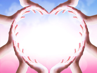 International Day of Friendship concept: hands in shape of heart on blurred  background