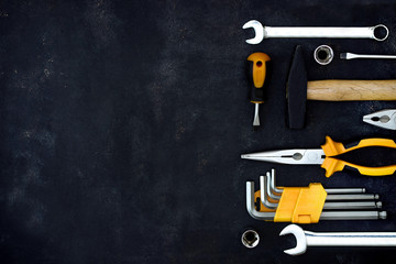 construction tools in wooden box in black background