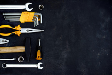 construction tools in wooden box in black background