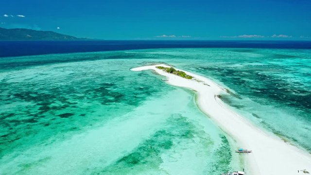 Truly amazing tropical island in the middle of the ocean. Aerial view of an island with white sand beaches and beautiful lagoons
