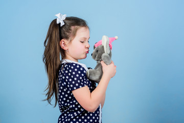 Childhood concept. Lovely small girl with favorite toy. Kindergarten and educational games. Spreading love. Kid cute girl play with soft toy mouse. Happy childhood. Child care. Sweet childhood