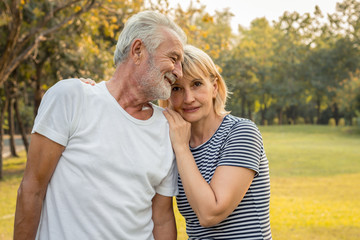 Senior couples hug each other and smile happily.