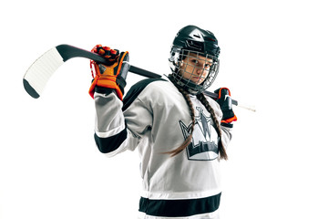 Young female hockey player isolated on white background. Sportswoman wearing equipment and helmet...