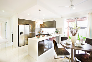 Modern refrigerator in the luxury kitchen with microwave ovens