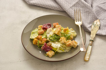 Healthy salad, caesar salad with croutons and dressing. Healthy foods.