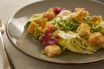 Close up caesar salad with croutons and dressing. Healthy foods.