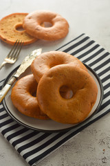 Bagels isolated on bright board for breakfast, top view. Copy space.