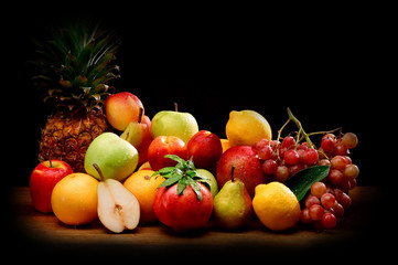 still life of fresh fruit lying on dark wood background