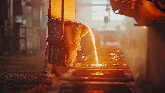 Hard work in the foundry. Pouring molten steel. Liquid steel pouring. Molten metal pouring, metallurgy, steel casting foundry. Steel manufacturing