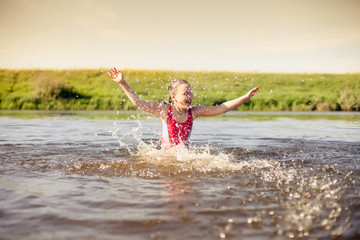  girl    swimming in   warm river.