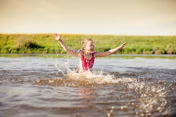 Fototapeta premium girl swimming in warm river.