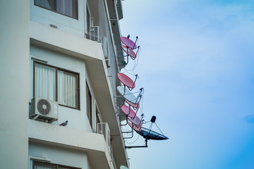 satellite dish on the high rise building wall