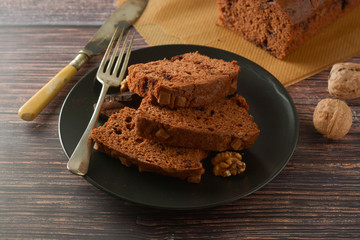 Piece of chocolate cake , fudge or pound cake. Wooden background.