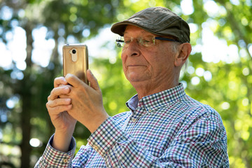 Distintas reacciones de un hombre mayor (abuelo) mirando las llamadas y los mensajes en su...